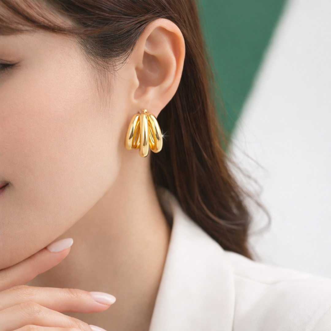 Pair of bold sculptural gold stud earrings with layered curved design