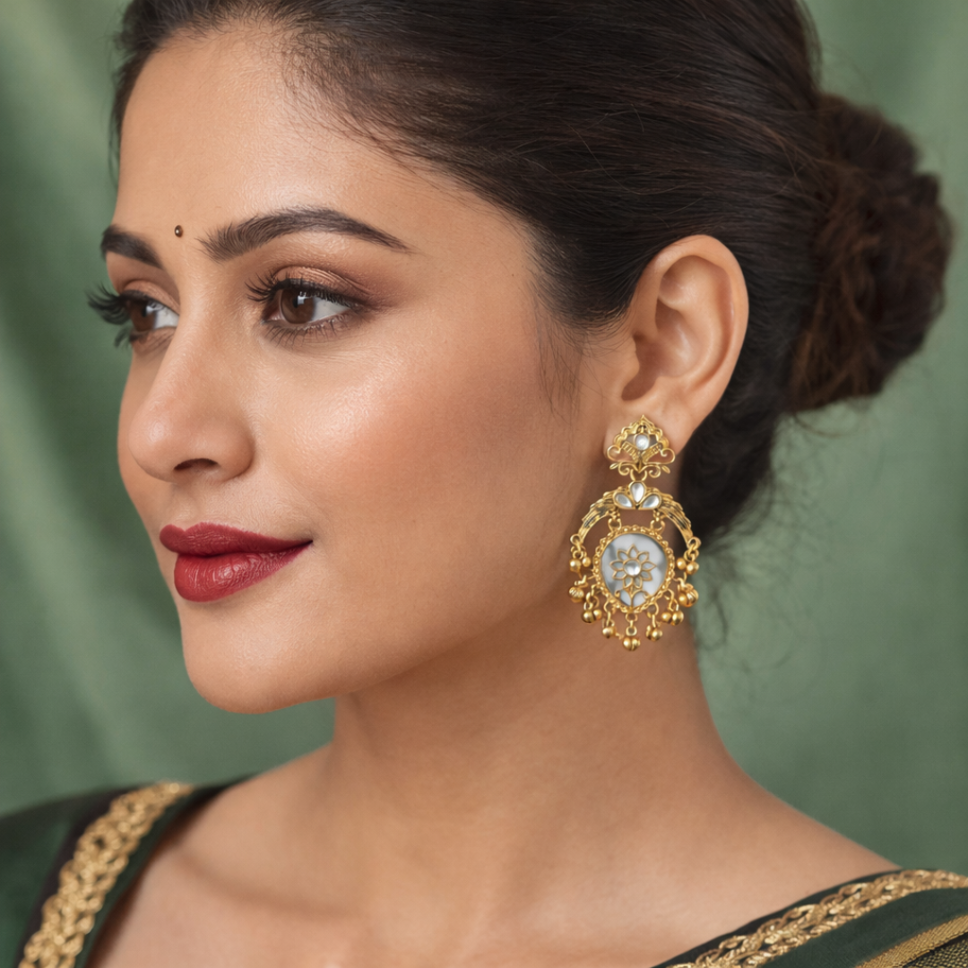 Close-up of gold and white floral Kundan earrings worn by a model.