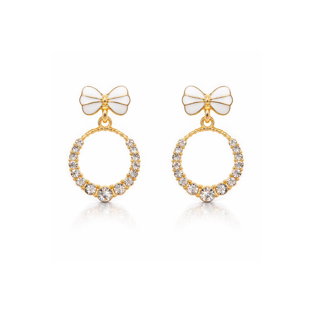 Close-up of gold bow hoop earrings with crystal accents worn by a model.