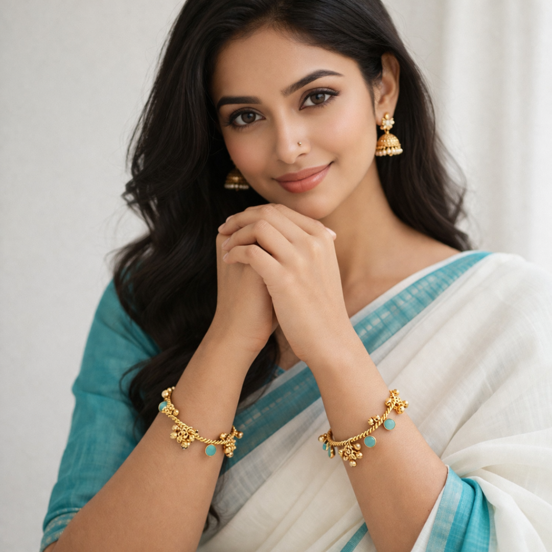 Woman wearing traditional gold turquoise charm bangles with ethnic Indian saree and jhumka earrings